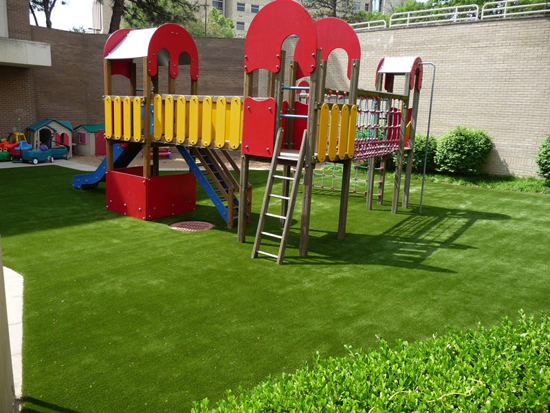 Child playset on artificial playground turf in Missouri