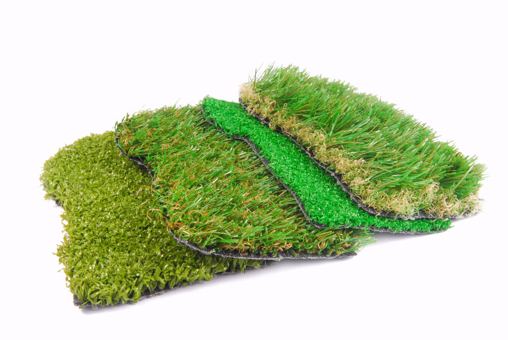 Types of artificial turf samples overlapping on white background