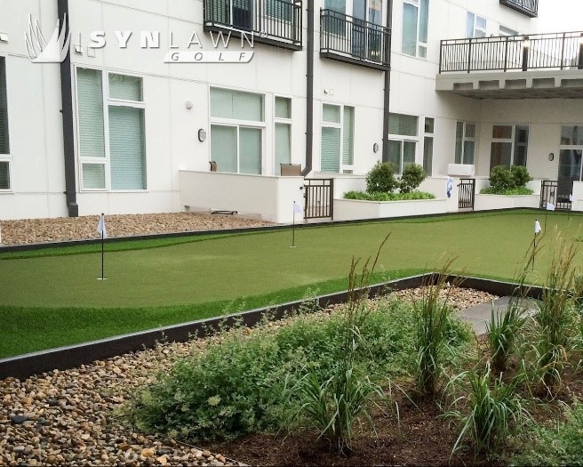 a golf putting green in an apartment complex